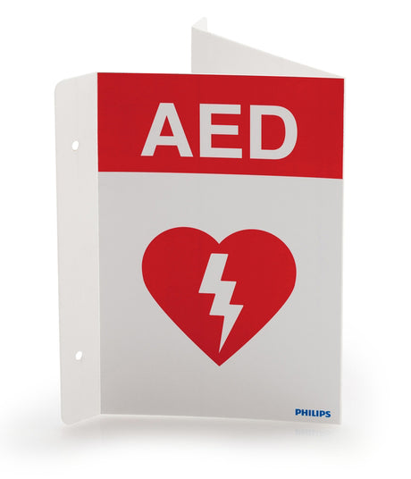 The Philips AED Wall Sign - Red, English by Philips features a red heart icon with a white lightning bolt, indicating the location of an Automated External Defibrillator. Designed to maximize visibility, this sign ensures that the defibrillator cabinet is easily located in an emergency.