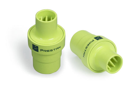 Two green Prestan Training Mask Adapters are placed on a white background.