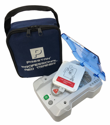The Prestan Professional AED Trainer PLUS, featuring pads revealed in its open lid, sits alongside a blue carrying case labeled with the Prestan brand name. It is designed to guide users through realistic training scenarios with clear voice prompts in both English and French.