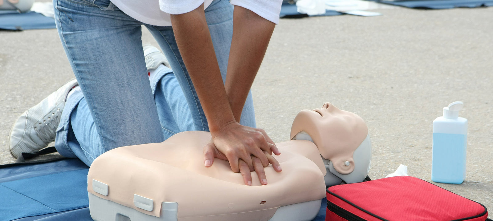 Person performing CPR on a manikin