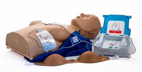 The AED Shop's PRESTAN Professional Adult Female Series 2000 Manikin offers Advanced CPR Feedback, Bluetooth App functionality, electrode pads, and an AED trainer device on a white background.