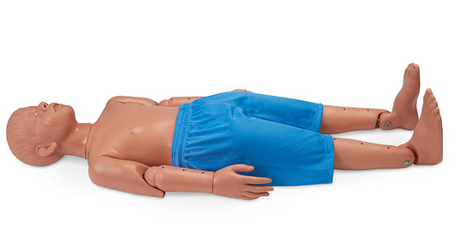 An Adolescent Water Rescue Manikin from Simulaids, made from durable vinyl plastic and resembling a child, is lying on its back. It features articulated joints and is wearing blue shorts. This manikin is specifically designed for practicing resuscitation techniques.