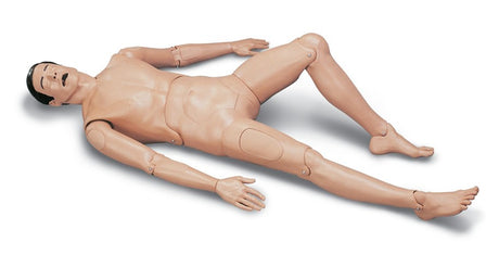 The Laerdal Crash Kelly, featuring adjustable limbs, lies on its back with its mouth open, ready for adult extrication and airway management exercises on a flat surface.