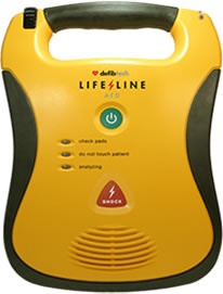 The Defibtech Lifeline AED Package is a semi-automatic defibrillator in yellow, equipped with a power button and status indicators, designed to offer vital support during sudden cardiac arrest.