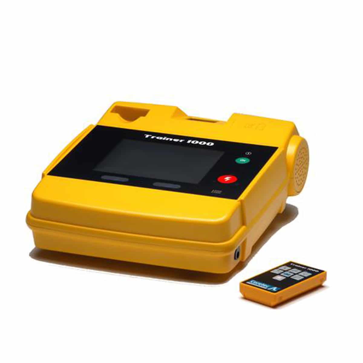Yellow defibrillator trainer device with screen and buttons, shown next to a small remote control.