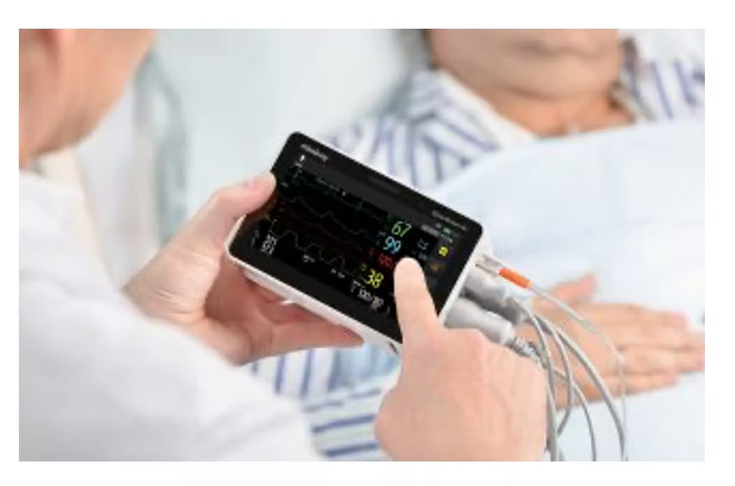 A healthcare worker adjusts settings on a Mindray BeneVision N1 portable patient monitor bedside.