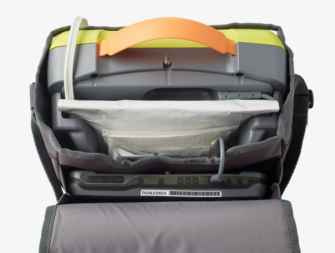 Close-up of The AED Shop’s AEDtrax, a portable medical device with a handle, tubing, and supply compartment, featuring AED monitoring for enhanced emergency readiness.