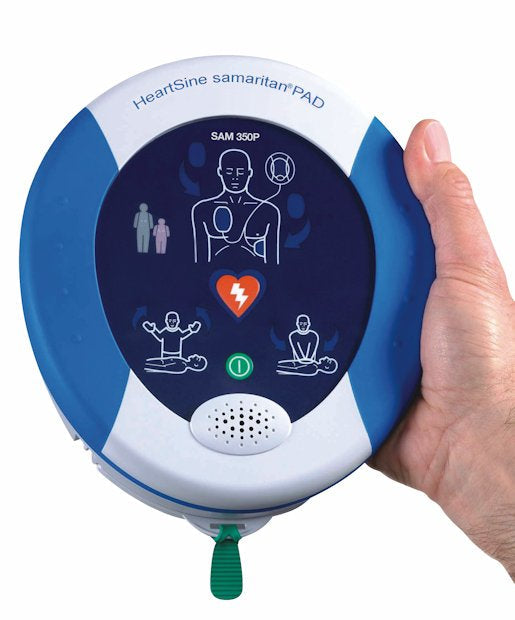 A person holds a portable HeartSine Samaritan 350P ENCORE Series (recertified) defibrillator, offering intuitive visual instructions on its display and powered by the advanced Pad-Pak cartridge.