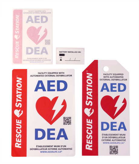 Three RescueStation AED Bonus Pack rescue station signs and a small battery replacement sticker are displayed on a white background.