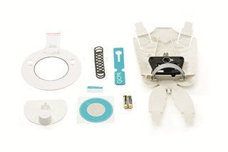 Presenting the Little Junior QCPR Upgrade Kit by Laerdal, a selection of white components and accessories for your device. This kit includes springs, batteries, and circular parts, all showcased on a white background. It's the perfect addition to enrich your training experience with the Little Junior QCPR app.