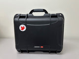 AEDShop's AED Hard Shell Case in black comes with a handle and offers ultimate protection. It features a sticker of a red maple leaf and a white circle on the upper left corner. This impact-resistant, waterproof case ensures your items stay safe in any environment.