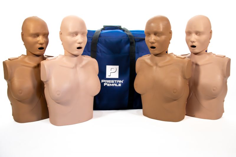 Four PRESTAN Professional Adult Female Manikins with CPR Feedback from AEDShop are arranged beside a blue Prestan bag, each featuring an advanced CPR rate monitor.