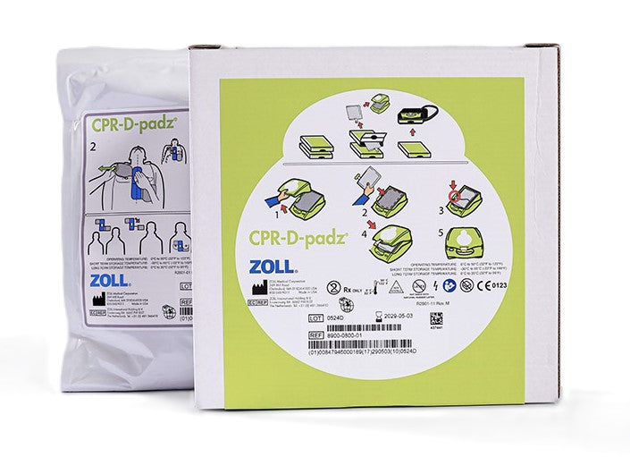 ZOLL CPR-D-padz packaging with illustrated instructions for use is displayed in brown and white boxes marked "ZOLL AED Plus" defibrillation system.