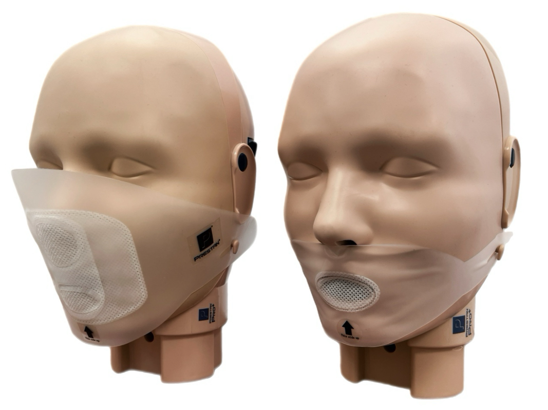 Two adult manikins equipped with transparent CPR masks featuring white respirator patches and AEDShop PRESTAN PRO+ Adult Face Shields from the 50-pack.