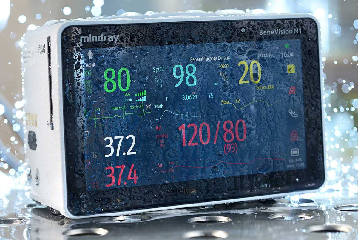 A Mindray BeneVision N1 patient monitor displaying vital signs, covered in water droplets.
