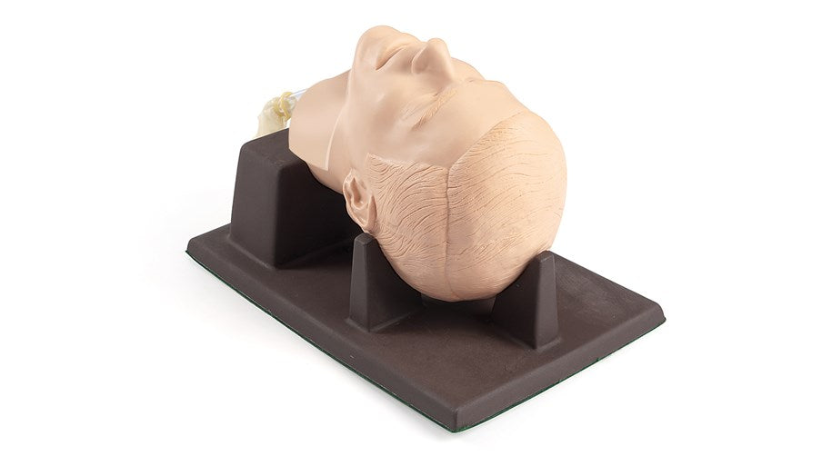 The Laerdal Cricoid Stick Trainer on a black base includes interchangeable tracheas, offering a realistic side view crucial for advanced medical procedures.