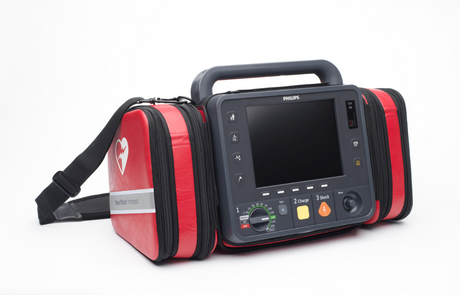 Philips HeartStart Intrepid Biphasic Defibrillator/AED in a red and black carry case with a screen and shoulder strap.